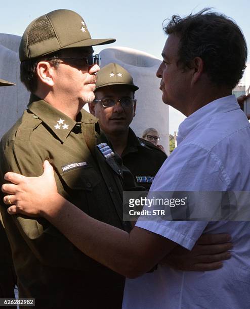 Alejandro Castro Espin , Raul Castro's son, offers his condolences to his cousin Antonio Castro Soto del Valle, Fidel Castro's son, at Revolution...