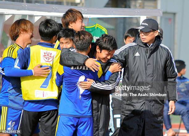 Imabari owner Takeshi Okada and members celebrate after securing the promotion to the Japan Football League after their 3-0 win in the National...