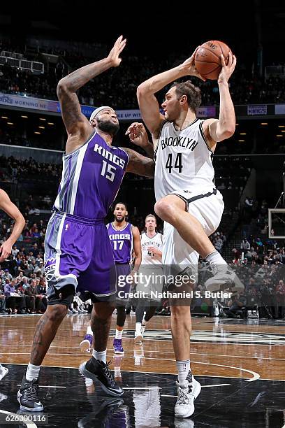 Bojan Bogdanovic of the Brooklyn Nets looks to pass the ball while guarded by DeMarcus Cousins of the Sacramento Kings on November 27, 2016 at...