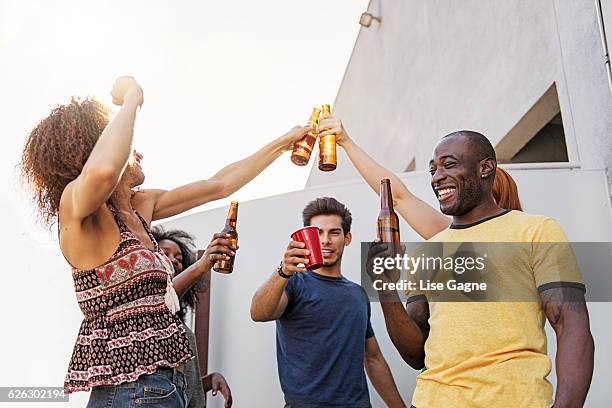 group of friends partying on balcony - lise gagne stock pictures, royalty-free photos & images