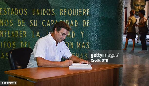 Antonio Castro Soto del Valle, Cuban revolutionary leader Fidel Castro's son, signs an oath of allegiance to his father's revolution concept at...