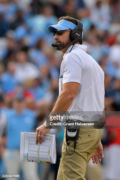 Head coach Larry Fedora of the North Carolina Tar Heels watches his team during their game against the North Carolina State Wolfpack at Kenan Stadium...