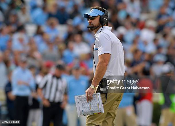 Head coach Larry Fedora of the North Carolina Tar Heels watches his team during their game against the North Carolina State Wolfpack at Kenan Stadium...