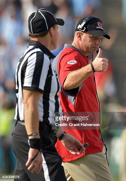 Head coach Dave Doeren of the North Carolina State Wolfpack directs his team during their game against the North Carolina Tar Heels at Kenan Stadium...
