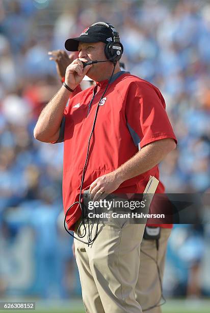 Head coach Dave Doeren of the North Carolina State Wolfpack directs his team during their game against the North Carolina Tar Heels at Kenan Stadium...