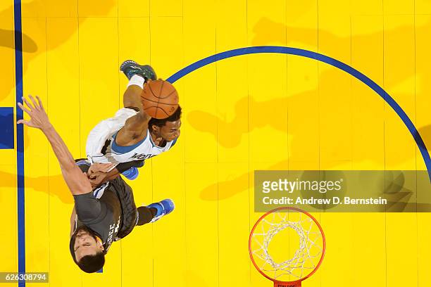 Andrew Wiggins of the Minnesota Timberwolves dunks the ball JaVale McGee of the Golden State Warriors during the game on November 26, 2016 at ORACLE...