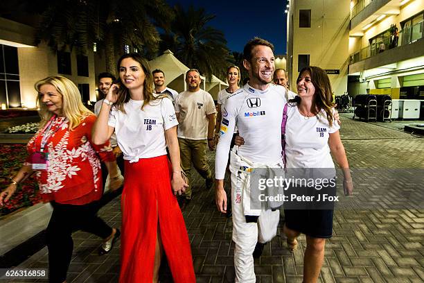 Jenson Button of Great Britain and Mclaren celebrates with his family and friends after retiring from his last F1 race during the Abu Dhabi Formula...