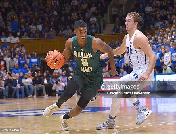 Daniel Dixon of the William & Mary Tribe drives against Luke Kennard of the Duke Blue Devils during the game at Cameron Indoor Stadium on November...