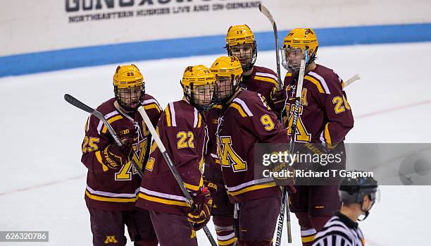 Justin Kloos of the Minnesota Golden Gophers celebrates his second of three goals against the Northeastern Huskies with his teammates Mike Szmatula,...