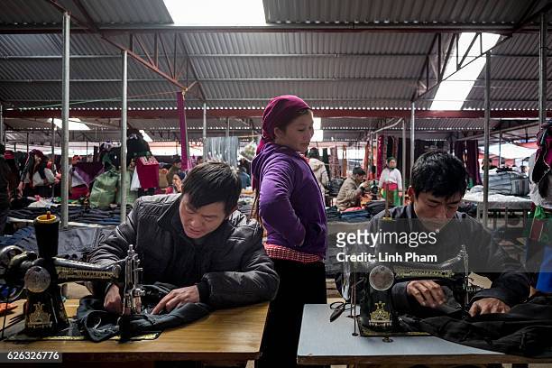 November 27, 2016: Local tailors fix customers' clothes at Dong Van Sunday Market, one of the furthest market up north near the border with China, in...