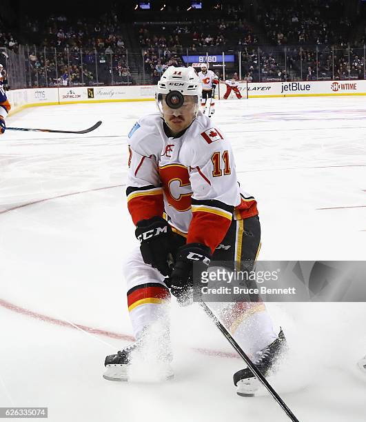 Mikael Backlund of the Calgary Flames is hit in the helmet by a loose puck during the game against the New York Islanders at the Barclays Center on...