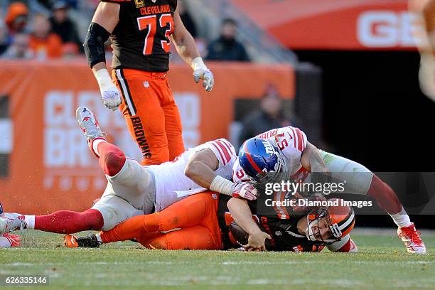 Quarterback Josh McCown of the Cleveland Browns is sacked by linebacker Keenan Robinson of the New York Giants during a game on November 27, 2016 at...