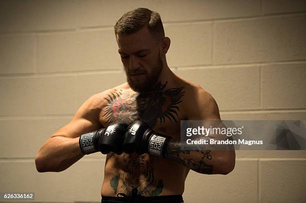Featherweight champion Conor McGregor of Ireland warms up backstage at Madison Square Garden prior to his lightweight championship fight against...