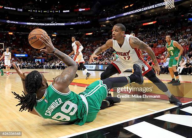 Rodney McGruder of the Miami Heat and Jae Crowder of the Boston Celtics fight for a loose ball during a game at American Airlines Arena on November...