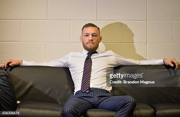 Featherweight champion Conor McGregor of Ireland relaxes backstage at Madison Square Garden prior to his lightweight championship fight against Eddie...