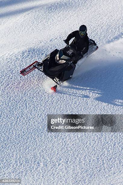 snowmobile rider - snow vehicle stock pictures, royalty-free photos & images