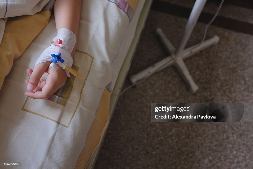 Child's hand with IV drip attached