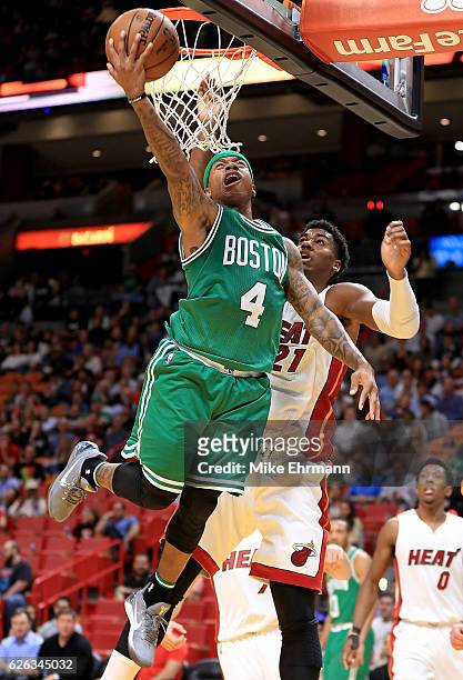 Isaiah Thomas of the Boston Celtics drives on Hassan Whiteside of the Miami Heat during a game at American Airlines Arena on November 28, 2016 in...
