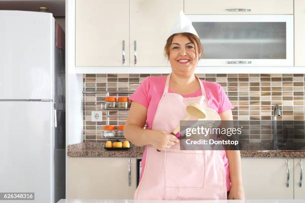 female chef or house wife holding kitchen tools - wife beater stock pictures, royalty-free photos & images