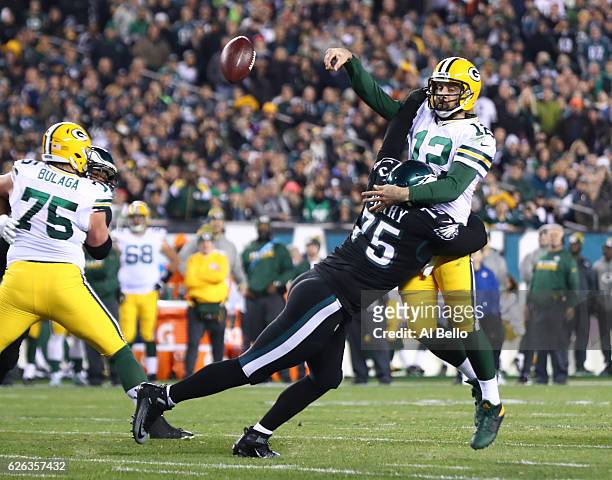 Vinny Curry of the Philadelphia Eagles hits Aaron Rodgers of the Green Bay Packers on a pass attempt in the fourth quarter at Lincoln Financial Field...