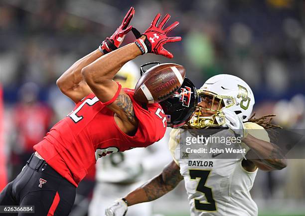 Antoine Wesley of the Texas Tech Red Raiders cannot make the catch while defended by Tion Wright of the Baylor Bears during the game on November 25,...