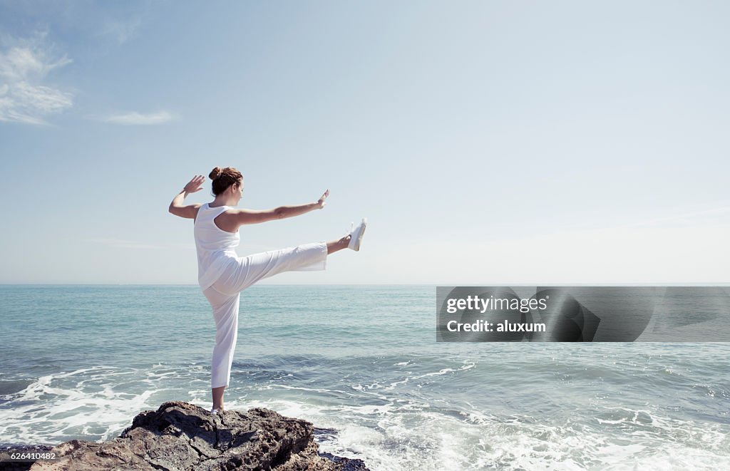 Woman exercising in front of the sea