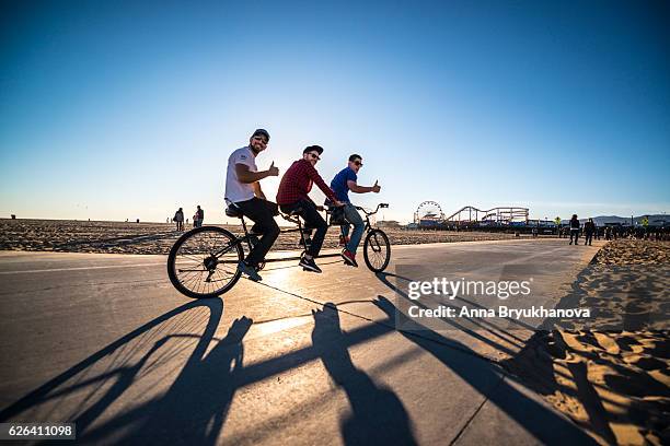 persone in bicicletta e jogging sulla spiaggia di santa monica, california, usa - tandem bicycle foto e immagini stock