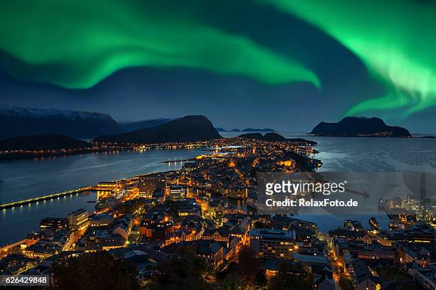 northern lights - green aurora borealis over alesund, norway - scandinavian culture stock pictures, royalty-free photos & images