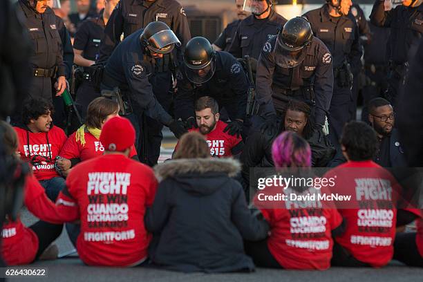 Striking McDonald's restaurant employees sitting in an intersection are arrested after walking off the job to demand a $15 per hour wage and union...