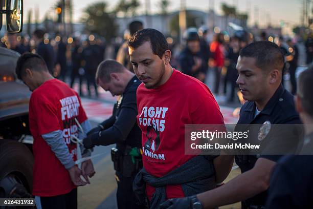 Striking McDonald's restaurant employees are arrested while sitting in an intersection after walking off the job to demand a $15 per hour wage and...