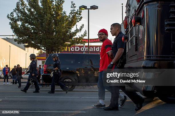 Striking McDonald's restaurant employees are arrested and put onto buses for sitting in an intersection after walking off the job to demand a $15 per...