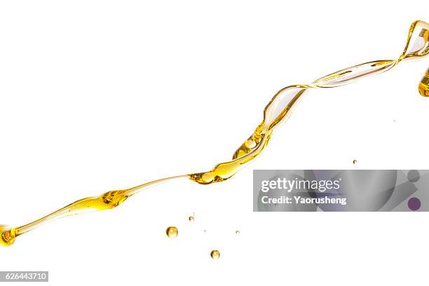 active oil splash in white background - oil flow imagens e fotografias de stock