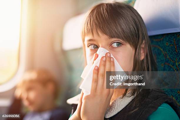 teenage girl blowing nose on train - cold virus stock pictures, royalty-free photos & images