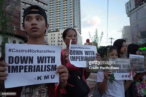 Activists hold placards and flowers during a rally commemorating the life of the late Cuban leader Fidel Castro. Workers from the Kilusang Mayo Uno...