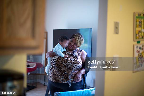 Sonya Ebhotemen holds her grandchild at home. As a Marine Corps veteran living with post-traumatic stress disorder , Sonya understands how important...