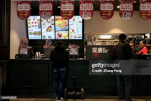 Customers order food in a KFC restaurant. As the largest restaurant chain in China, with more than 7,000 outlets, KFC makes new strategy including...