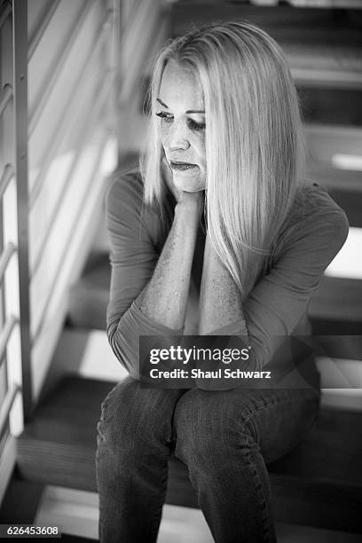 Suzy Favor Hamilton poses for a portrait on the stairs of her home. Suzy is a three-time Olympian, writer, advocate, wife and mother. With incredible...