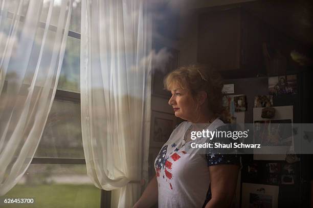 Terry Taggart stares out the window of her home. Terry lives with bipolar disorder and post-traumatic stress disorder . She devotes her time to two...