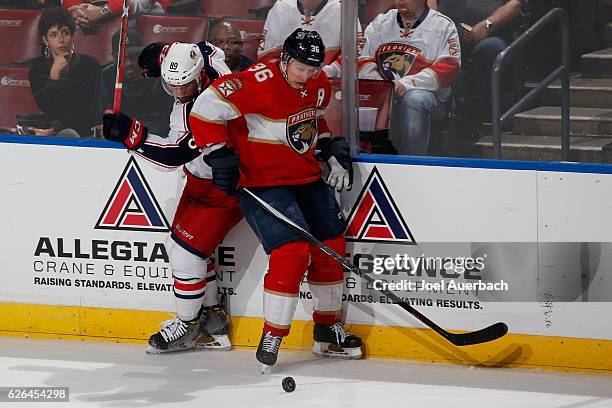 Sam Gagner of the Columbus Blue Jackets and Jakub Kindl of the Florida Panthers battle for control of the puck at the BB&T Center on November 26,...