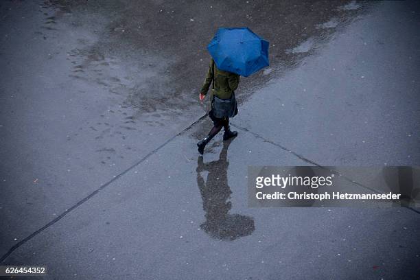 rainy - raining umbrella stock pictures, royalty-free photos & images