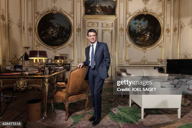 French Prime Minister Manuel Valls poses during a photo session in his office at the Hotel de Matignon in Paris on November 24, 2016.