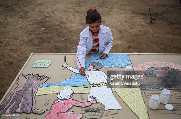 Palestinian girl paints a mosaic during Palestinian cultural heritage event organised by Cultural and Free Thought Association in Khan Yunis, Gaza on...