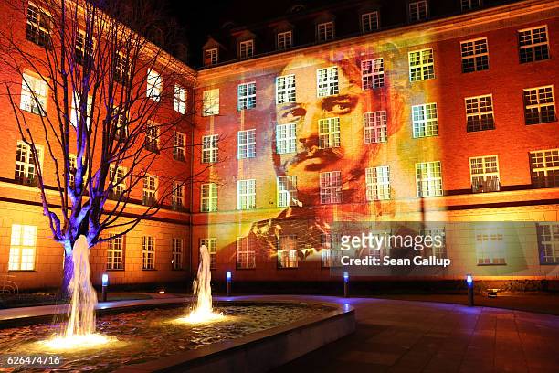 The Berlin headquarters of Siemens AG are seen illuminated with an image of the company's founder, Werner von Siemens, during his 200th birthday...
