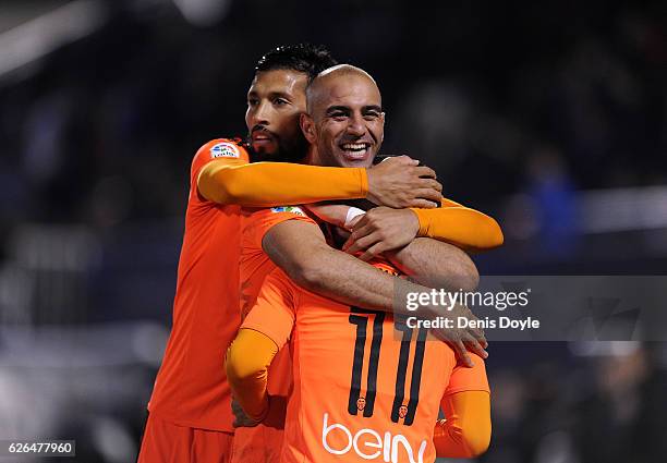 Zakaria Bakkali of Valencia CF is congratulated byAymen Abdennour and Ezequiel Garay after scoring his team's 3rd goal during the Copa del Rey Round...