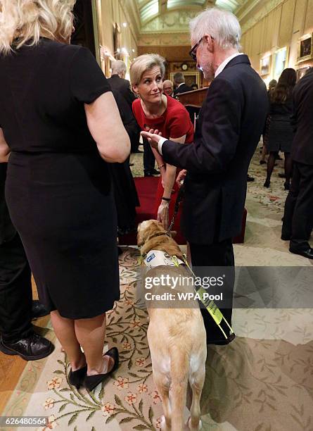 Sophie, Countess of Wessex speaks to a guest with a guide dog during a reception to celebrate the patronages of the Princess, in the year of her 80th...