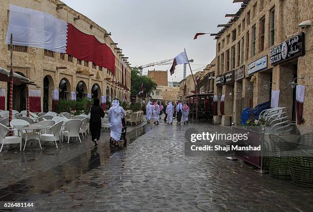 family walking in a qatar market / souk - doha street stock pictures, royalty-free photos & images