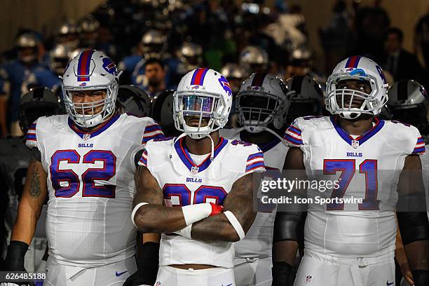 Buffalo Bills tackle Chris Martin , Buffalo Bills running back James Wilder Jr. , and Buffalo Bills tackle Cyrus Kouandjio wait to take the field...