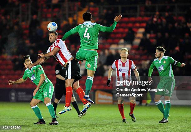 Lincoln City's Matt Rhead vies for possession with Wrexham's Hamza Bencherif during the Vanarama National League match between Lincoln City and...