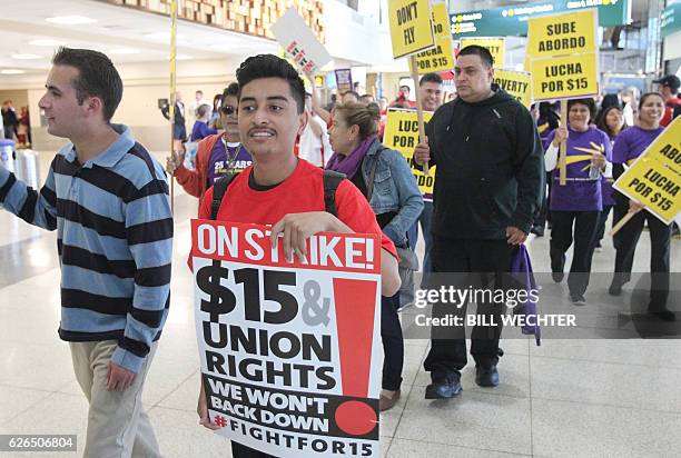 Marching through one of the terminals, some 200 low-wage workers take part in a protest named "Day of Disturbance" to demand higher wages on November...