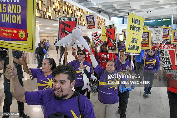 Marching through one of the terminals, some 200 low-wage workers take part in a protest named "Day of Disturbance" to demand higher wages on November...